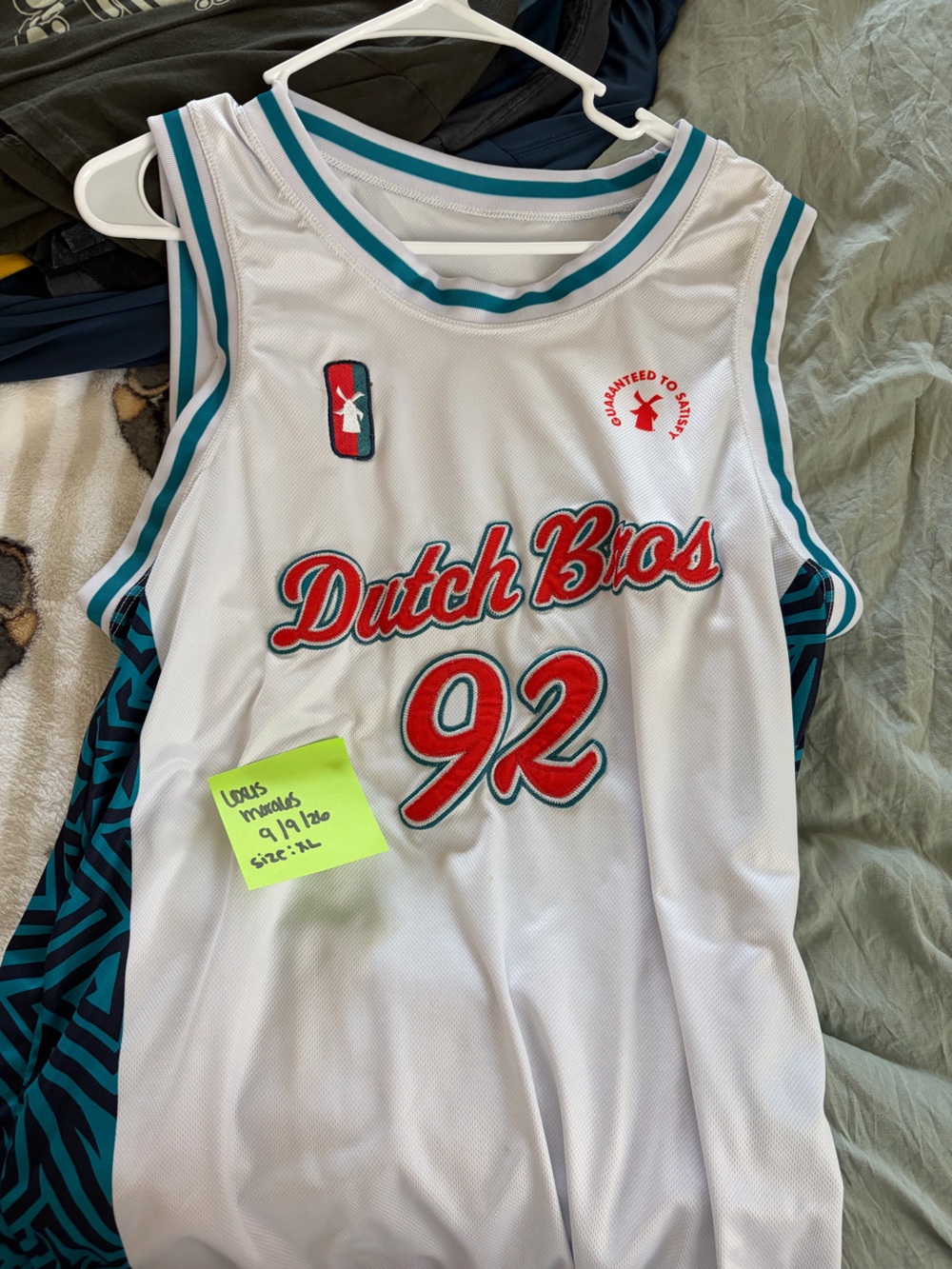Dutch Bros White Jersey with Teal Trim and Red Accents